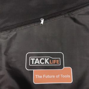 Close-up of black drawstring bag front zipper with metal pull tab