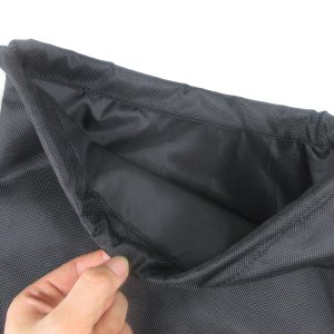 Black textured drawstring backpack opened showing smooth inner lining