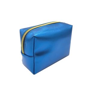 Close-up of gold metal zipper pull on blue metallic cosmetic pouch