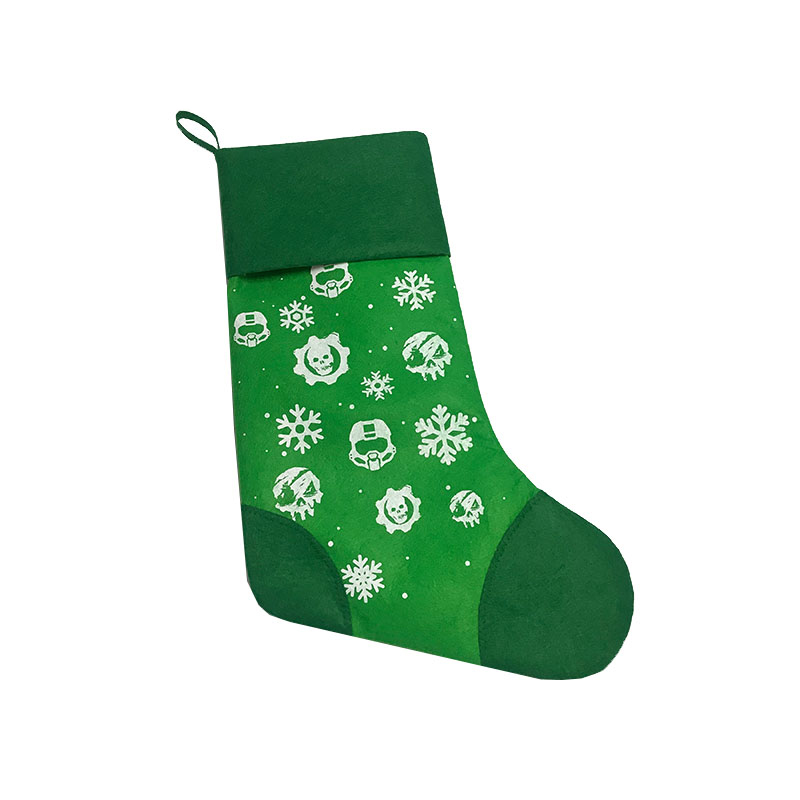 Green felt holiday stocking with printed helmets and snowflakes side view