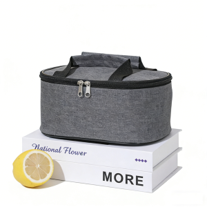 Grey heather thermal lunch bag displayed on white books with a cut lemon