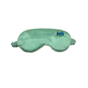 Mint green faux silk sleep mask front view with white piping trim