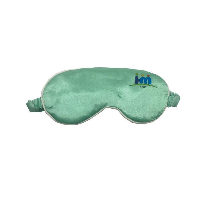 Mint green faux silk sleep mask front view with white piping trim