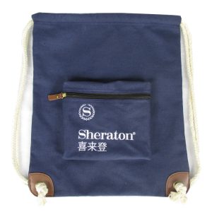 Navy canvas backpack with zipper pocket and leather corner patches