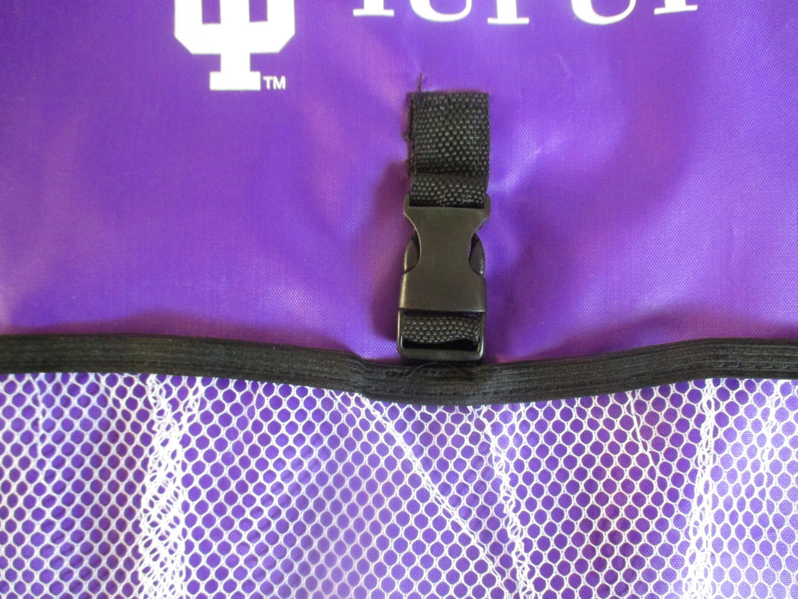 Black plastic center buckle detail on purple mesh pocket drawstring bag