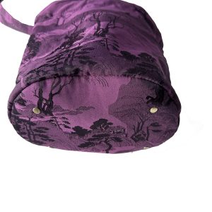 Full front view of purple jacquard drawstring bucket crossbody bag with tassel