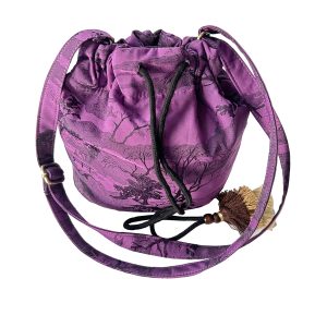 Full front view of purple jacquard drawstring bucket crossbody bag with tassel