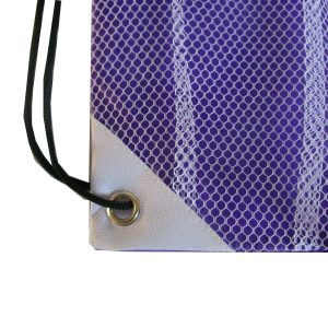 White reinforced corner patch with metal grommet on purple mesh drawstring bag