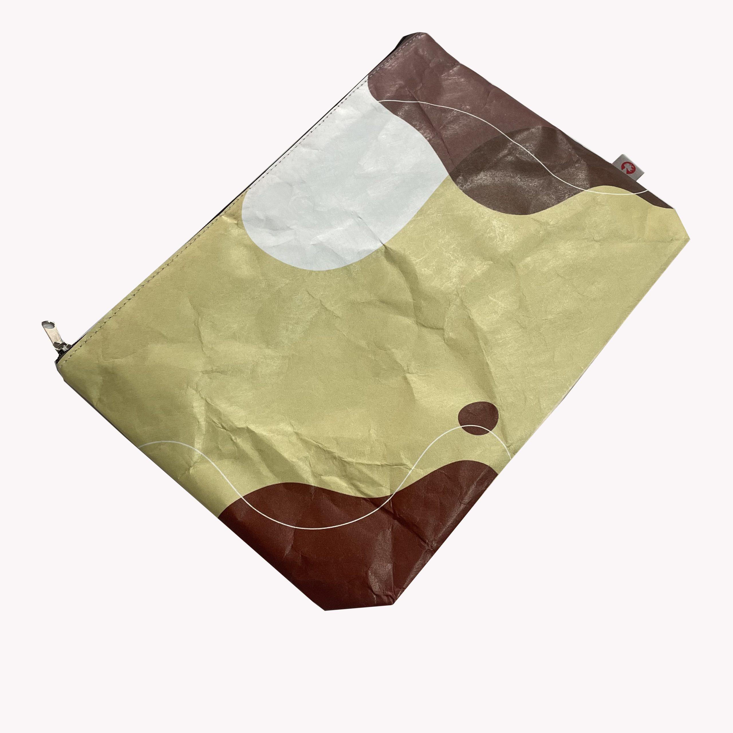 Angled view of beige Tyvek zip pouch with abstract geometric pattern