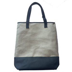 Beige woven tote bag front view with black bottom and black webbing handles