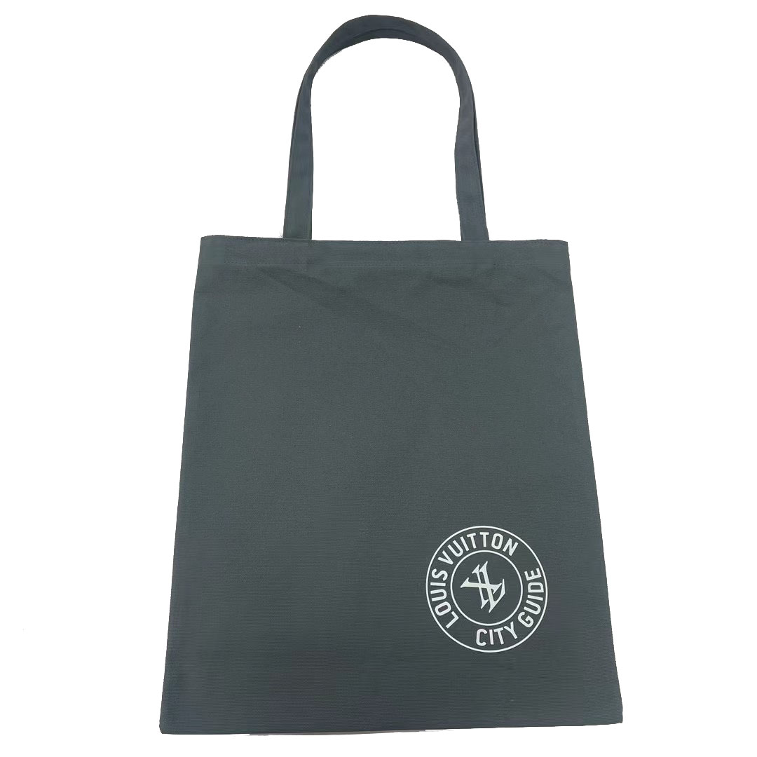Black minimalist canvas tote bag with white circular logo printed on the bottom right
