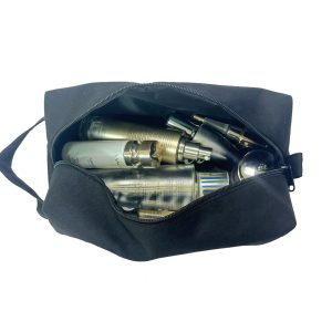 Black cosmetic bag filled with skincare bottles and makeup angled open view