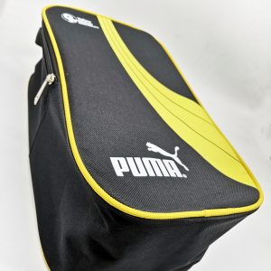 Angled view of black sports gear bag with yellow piping and silk-screen print