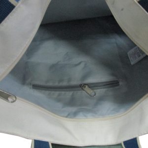 Light blue interior lining and gray zipper pocket of canvas tote bag