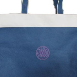 Purple institutional circular logo printed on blue canvas tote bag