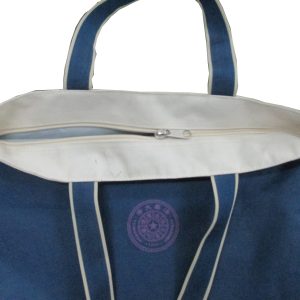 White top zipper closure detail on blue canvas tote bag