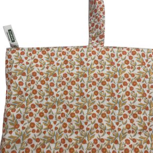 Close-up of top zipper and custom woven label on floral tote bag