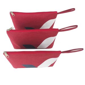 Stack of burgundy geometric logo zipper pouches with side wrist straps