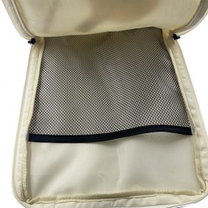 Interior mesh pocket with black zipper inside cream children's gift bag