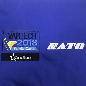 Close-up of embroidered patch and white screen-printed MATO logo on navy blue bag