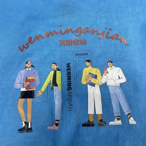 Close-up of custom fashion print graphic on blue tote bag