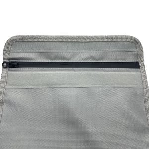 Close-up of black zipper and woven edge binding on grey sleeve