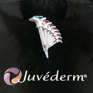 Close-up of colorful syringe graphic and Juvederm brand logo on black promotional bag