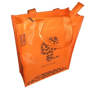 Orange tote bag side angle view showing zipper and side tag