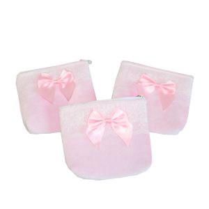Three pink velvet bow coin pouches arranged in a circle display