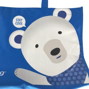 Close-up of cute polar bear print and speech bubble on blue tote bag