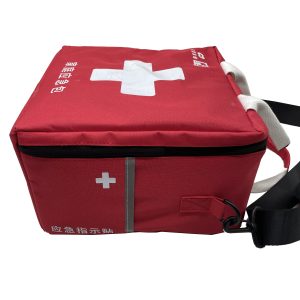 Side view of red emergency bag featuring white cross and reflective safety strip