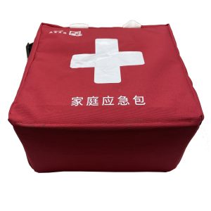 Top view of red family emergency bag with white cross and text print