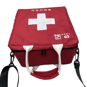Red portable emergency kit bag with white woven handles and black shoulder strap