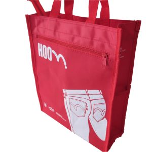 Red tote bag side view showing side pocket and white graphic print