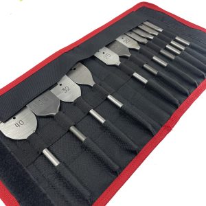 Close-up of elastic webbing slots securing spade drill bits in tool pouch