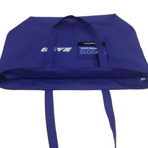 Top zipper closure and interior view of navy blue tote bag showing long handles