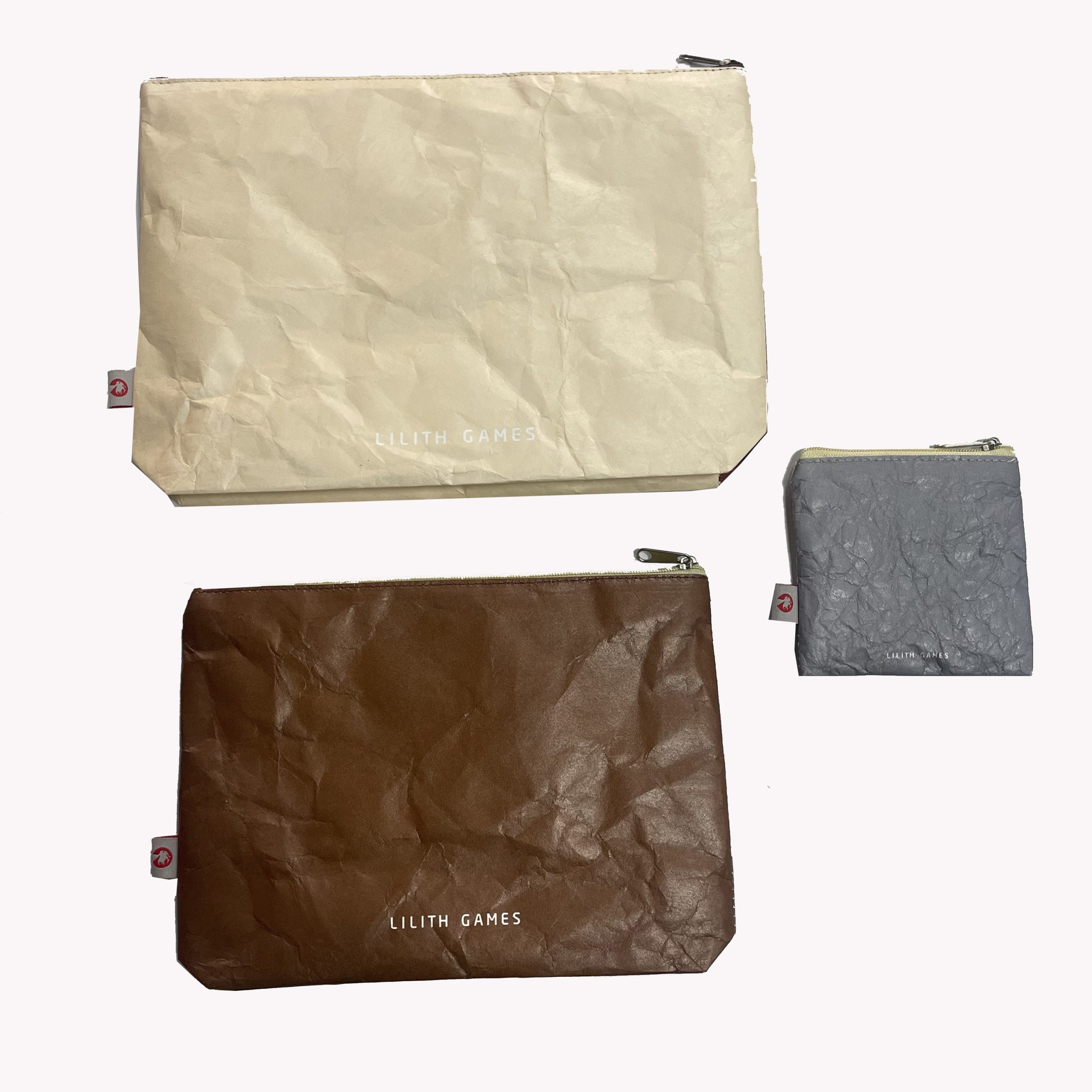 Set of Tyvek coin purses in beige, brown, and grey with side brand labels