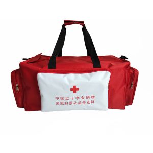 White front pocket of red duffel bag with red cross and charity donation print