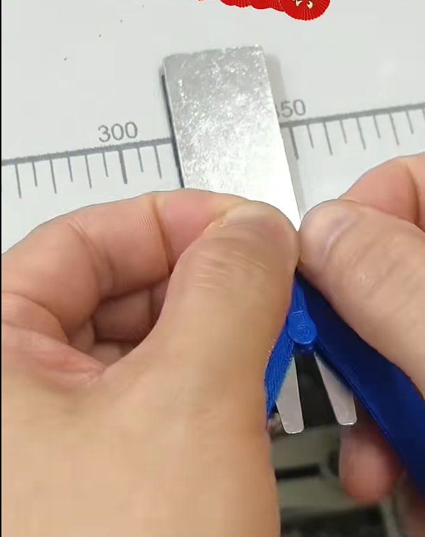 Close‑up shot of blue nylon zipper slider for custom bag hardware inspection