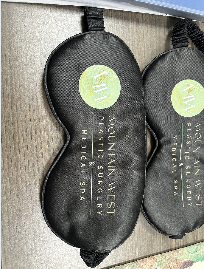 Custom printed black satin sleep masks with corporate logo for B2B promotional gifts